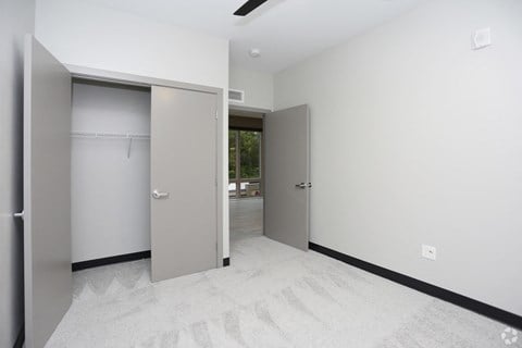 an empty room with two closet doors in it